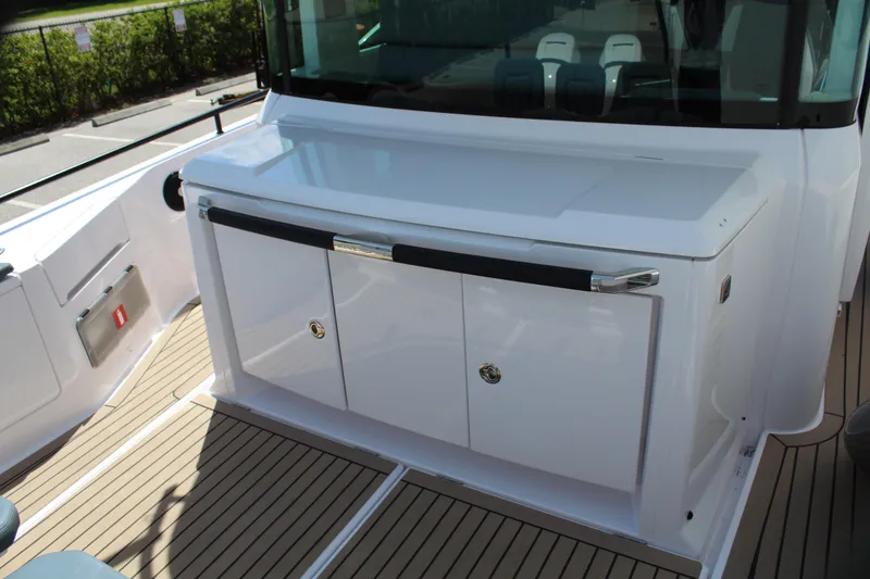 Slide: The Image of 2022 Axopar 37 XC Cross Cabin Brabus deck with storage cabinets. - 23