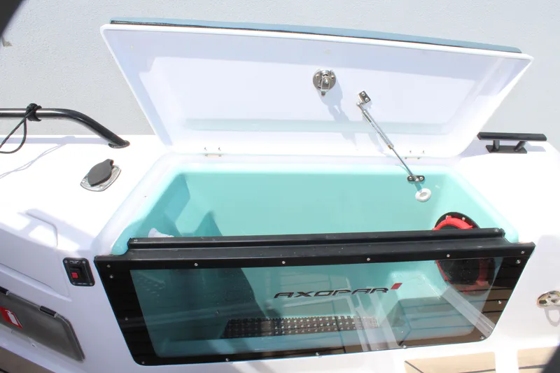 Slide: The Image of Axopar 37 XC Cross Cabin Brabus 2022 storage compartment with open lid and transparent window. - 31