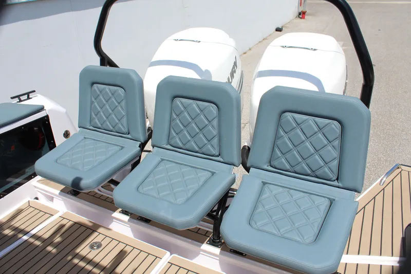 Slide: The Image of Three blue cushioned seats on a 2022 Axopar 37 XC Cross Cabin Brabus boat. - 22