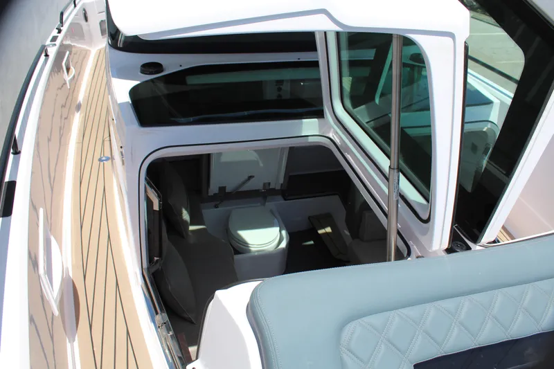 Slide: The Image of 2022 Axopar 37 XC Cross Cabin Brabus interior view with seating and toilet. - 39