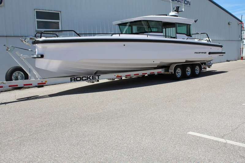 Slide: The Image of 2022 Axopar 37 XC Cross Cabin Brabus on a Rocket trailer outside a warehouse. - 12