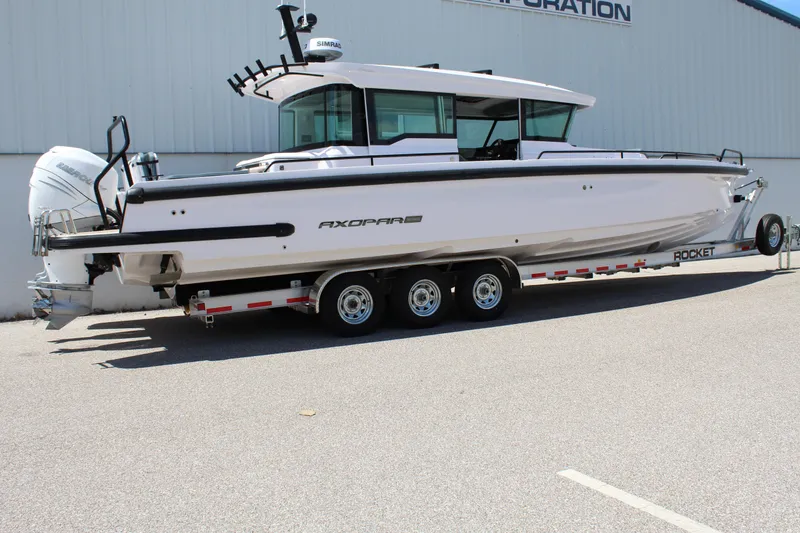 Slide: The Image of 2022 Axopar 37 XC Cross Cabin Brabus on a trailer, side view. - 3