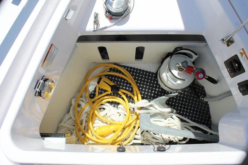 Slide: The Image of Storage compartment of a 2022 Axopar 37 XC Cross Cabin Brabus with anchor, ropes, and equipment. - 46