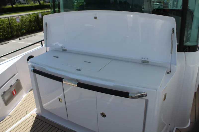 Slide: The Image of 2022 Axopar 37 XC Cross Cabin Brabus, rear deck storage and seating area. - 26