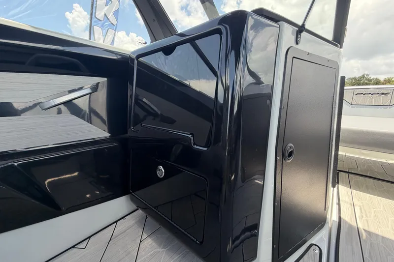 Slide: The Image of 2024 Yamaha Boats 222XD interior detail with sleek black cabinetry and modern design elements. - 18