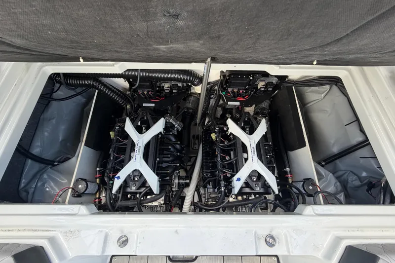 Slide: The Image of 2024 Yamaha Boats 222XD engine compartment with dual engines and wiring. - 69
