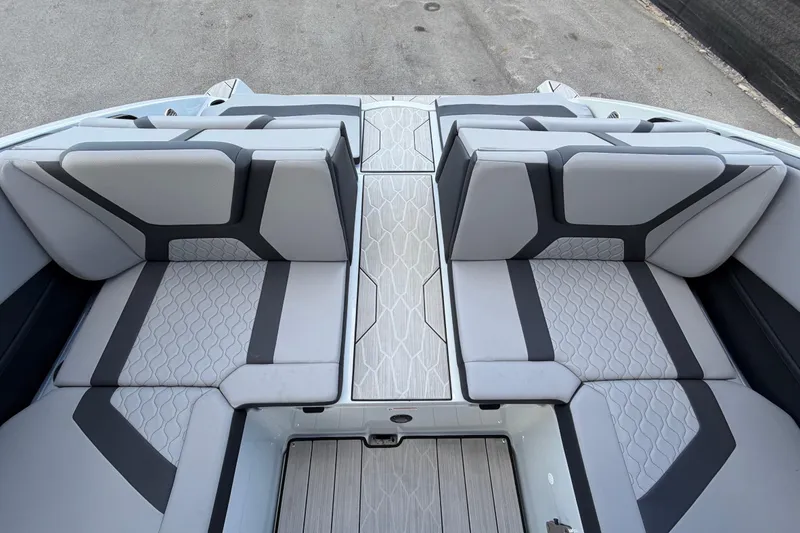 Slide: The Image of 2024 Yamaha Boats 222XD interior seating with modern design and gray upholstery. - 67