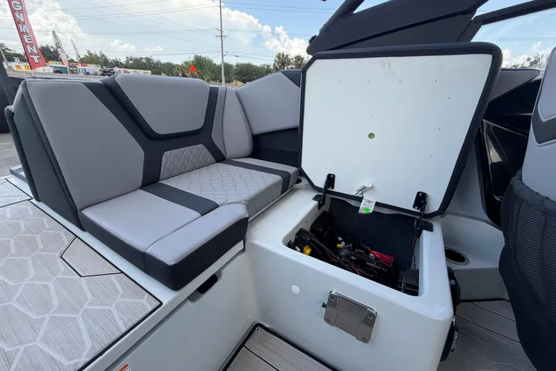 Slide: The Image of 2024 Yamaha Boats 222XD interior with open storage compartment and cushioned seating. - 64