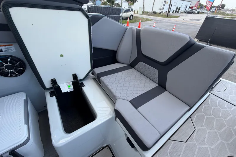 Slide: The Image of 2024 Yamaha Boats 222XD interior with gray seating and storage compartment open. - 62