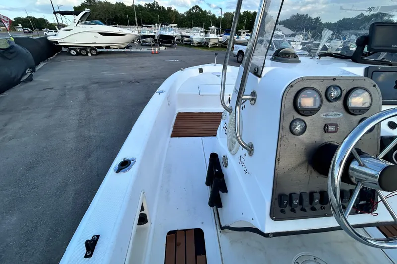 Slide: The Image of 1999 Hydra-Sports 2000 CC boat interior with steering console, docked at marina. - 21
