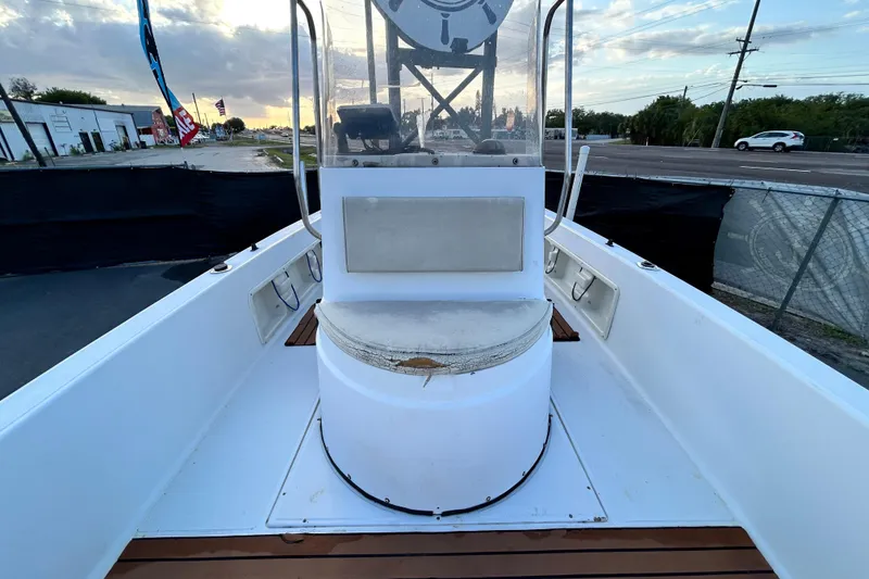 Slide: The Image of 1999 Hydra-Sports 2000 CC boat interior with console and seating, parked outdoors. - 31