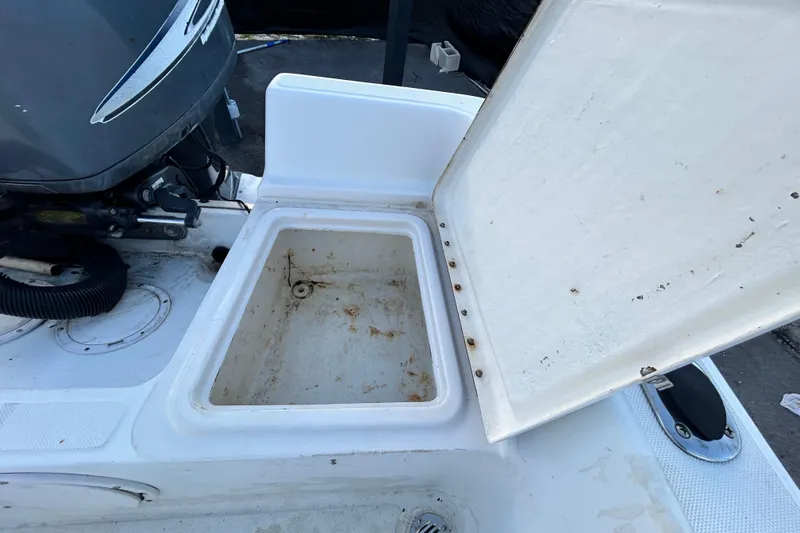 Slide: The Image of Open storage compartment on a 1999 Hydra-Sports 2000 CC boat, near the engine. - 40
