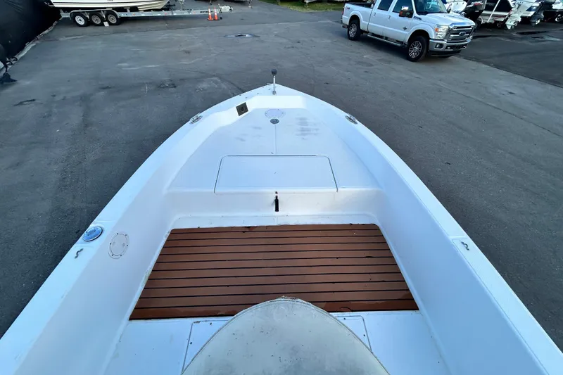 Slide: The Image of 1999 Hydra-Sports 2000 CC boat with wooden deck, parked near a white truck. - 24