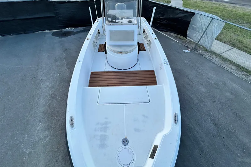 Slide: The Image of 1999 Hydra-Sports 2000 CC boat, white deck, wooden accents, parked on pavement. - 28