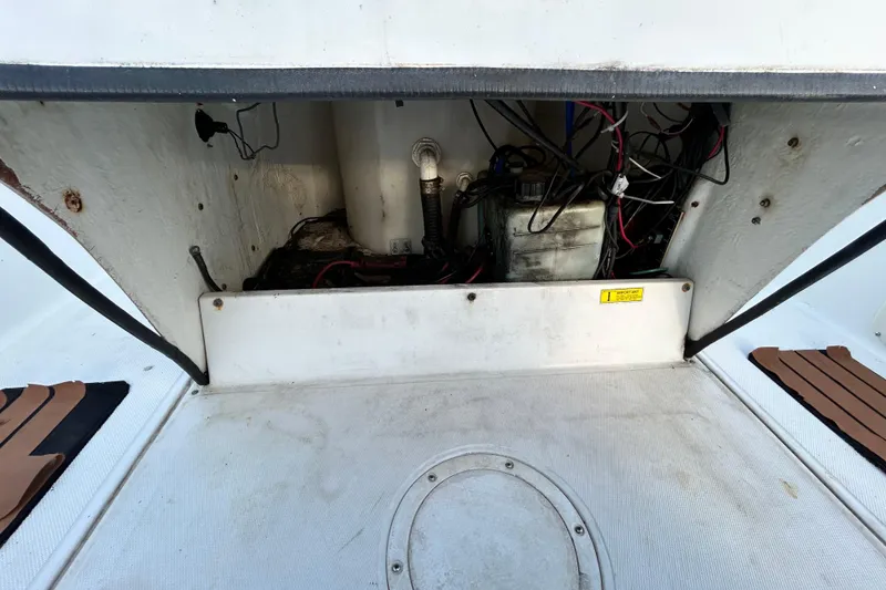 Slide: The Image of Open compartment of a 1999 Hydra-Sports 2000 CC boat showing wiring and battery. - 43