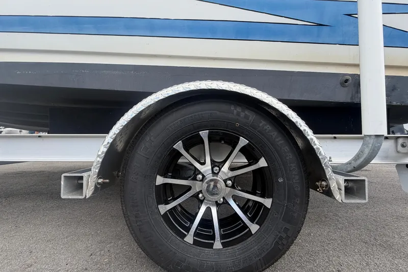 Slide: The Image of Trailer wheel of a 1999 Hydra-Sports 2000 CC boat on pavement. - 50