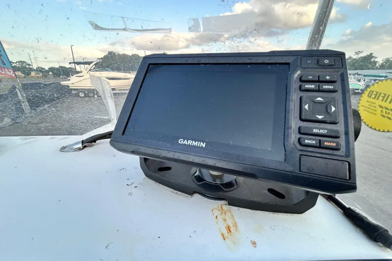 Slide: The Image of Garmin GPS device on 1999 Hydra-Sports 2000 CC boat dashboard, marina background. - 18