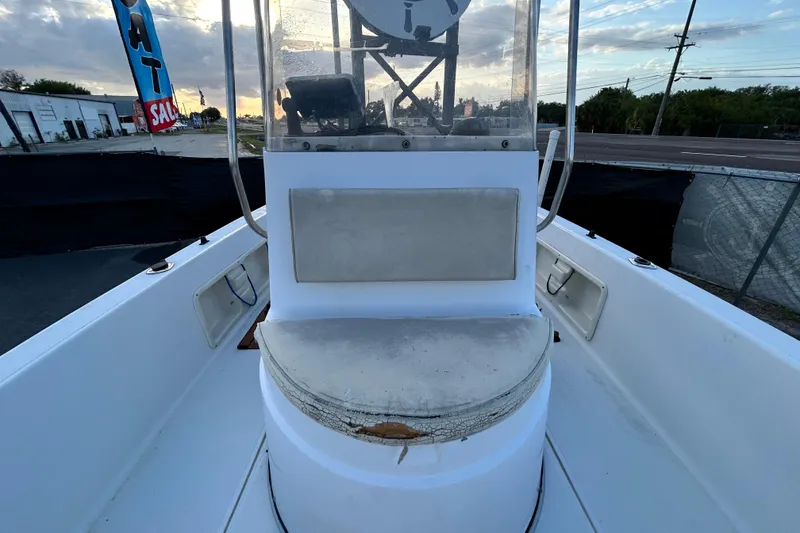 Slide: The Image of 1999 Hydra-Sports 2000 CC boat interior with seating and console, under a cloudy sky. - 32