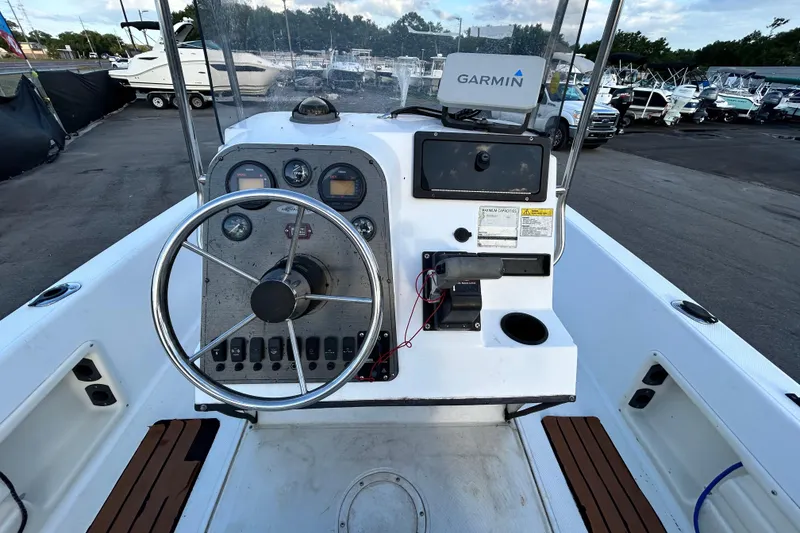 Slide: The Image of 1999 Hydra-Sports 2000 CC boat dashboard with Garmin navigation system in marina setting. - 14