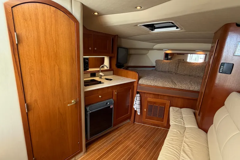 Slide: The Image of 2007 Rampage 30 Express cabin interior with kitchenette, bed, and seating area. - 44
