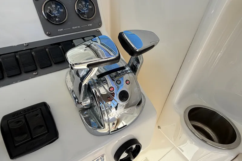 Slide: The Image of Chrome throttle controls on a 2007 Rampage 30 Express boat dashboard. - 31