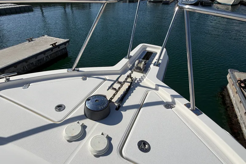 Slide: The Image of Bow of 2007 Rampage 30 Express boat with anchor chain and winch in marina. - 40