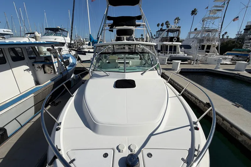 Slide: The Image of 2007 Rampage 30 Express boat docked at a marina with clear blue skies. - 35