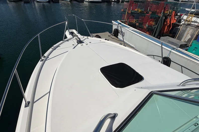 Slide: The Image of 2007 Rampage 30 Express boat docked at marina, view of bow and railing. - 36