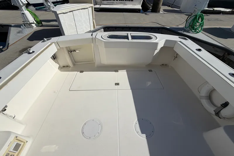 Slide: The Image of 2007 Rampage 30 Express boat deck with storage compartments and clean layout. - 18