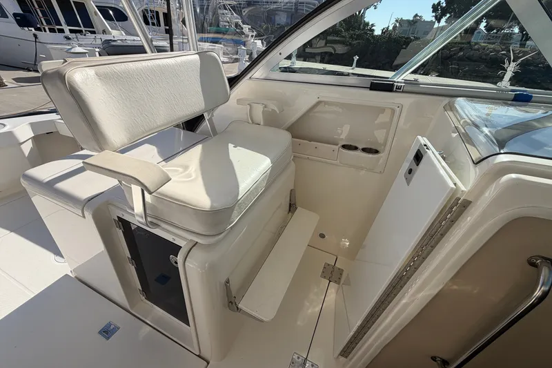 Slide: The Image of 2007 Rampage 30 Express boat interior with white seating and storage compartments. - 34