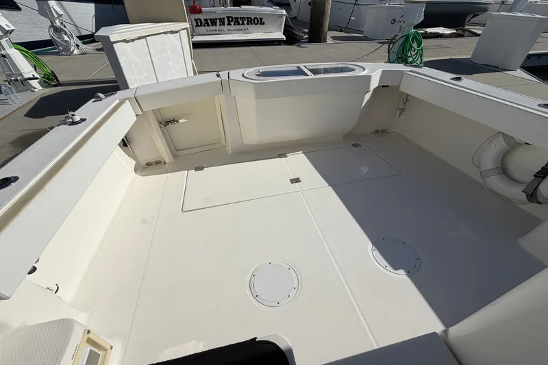 Slide: The Image of 2007 Rampage 30 Express boat deck, spacious and clean, docked at marina. - 19