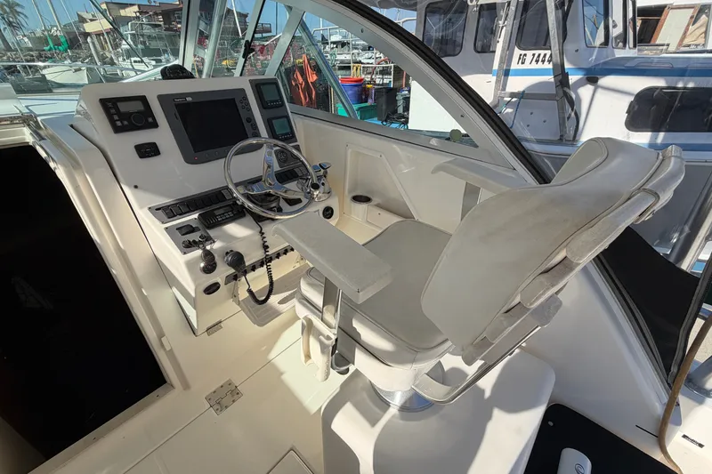 Slide: The Image of Helm of 2007 Rampage 30 Express boat with steering wheel and navigation controls. - 27