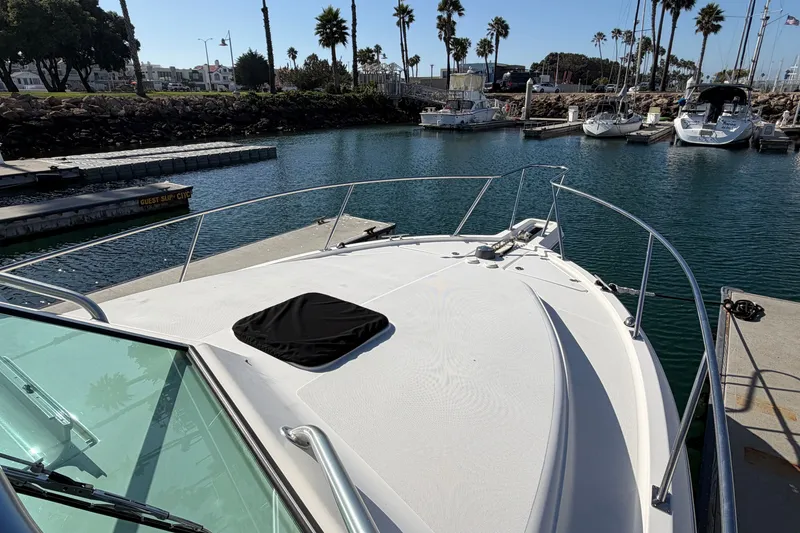 Slide: The Image of 2007 Rampage 30 Express boat docked in a marina with palm trees. - 37