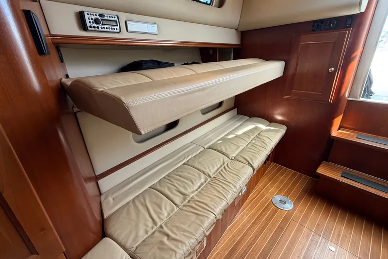 Slide: The Image of Interior of 2007 Rampage 30 Express boat with beige seating and wooden accents. - 47