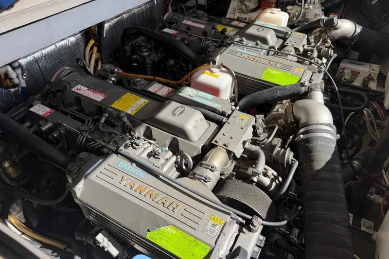 Slide: The Image of Engine compartment of a 2007 Rampage 30 Express boat, featuring Yanmar engines. - 56