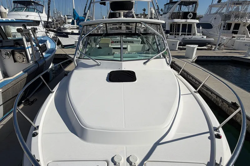 Slide: The Image of 2007 Rampage 30 Express boat docked at a marina, surrounded by other vessels. - 39