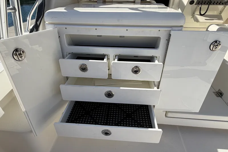 Slide: The Image of Open storage drawers on a 2007 Rampage 30 Express boat. - 23