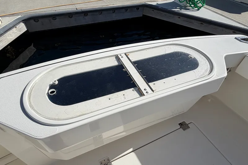 Slide: The Image of Livewell on 2007 Rampage 30 Express boat, featuring a sleek white design. - 20