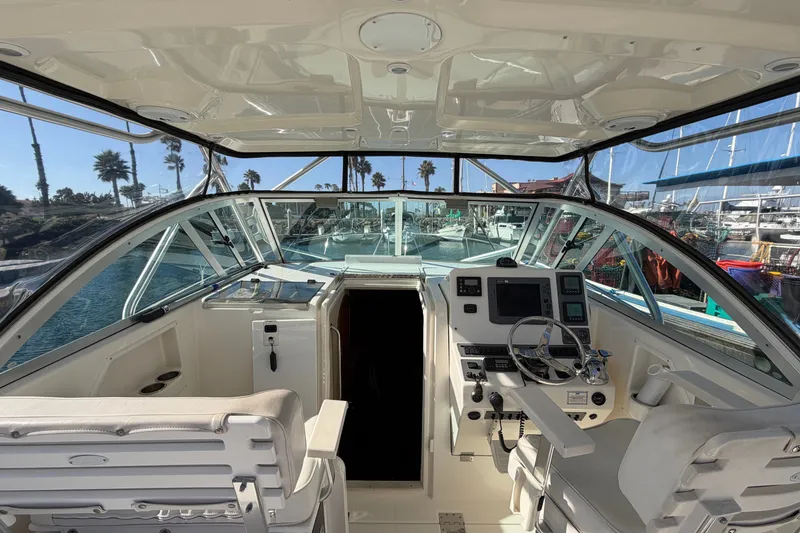 Slide: The Image of Interior view of a 2007 Rampage 30 Express boat cockpit with steering and navigation equipment. - 26