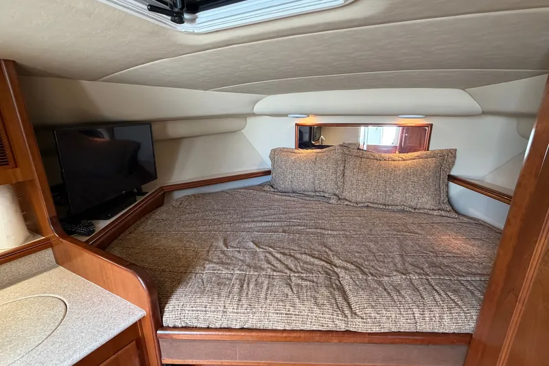 Slide: The Image of Cozy cabin interior of 2007 Rampage 30 Express with bed and TV. - 50