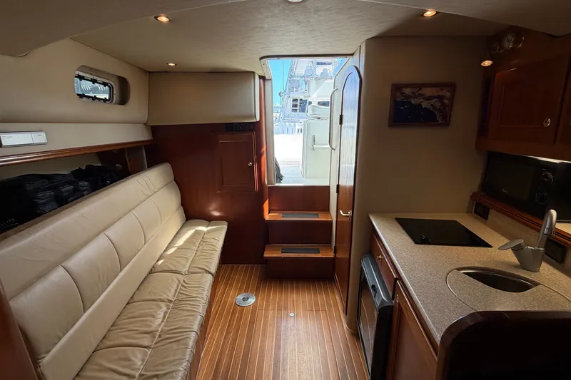 Slide: The Image of Luxurious interior of a 2007 Rampage 30 Express boat with seating and kitchenette. - 51