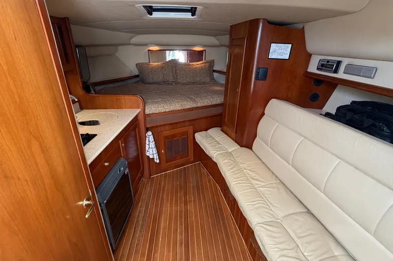 Slide: The Image of Luxurious interior of a 2007 Rampage 30 Express boat with cozy seating and wood finishes. - 43