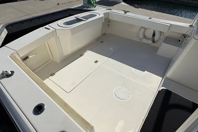 Slide: The Image of 2007 Rampage 30 Express boat deck with storage compartments and safety equipment. - 17