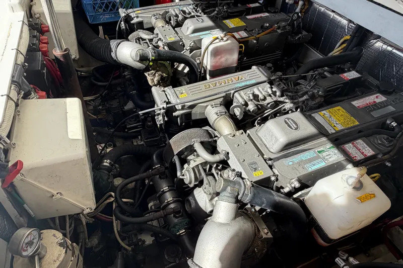 Slide: The Image of Engine compartment of a 2007 Rampage 30 Express boat, showcasing dual Yanmar engines. - 58