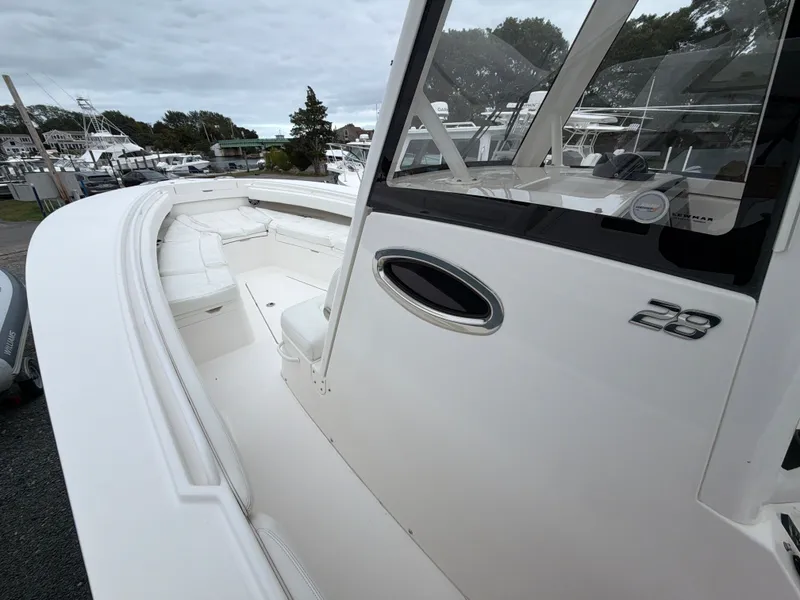 Slide: The Image of 2021 Regulator 28 with spacious deck and modern helm console at the marina. - 29