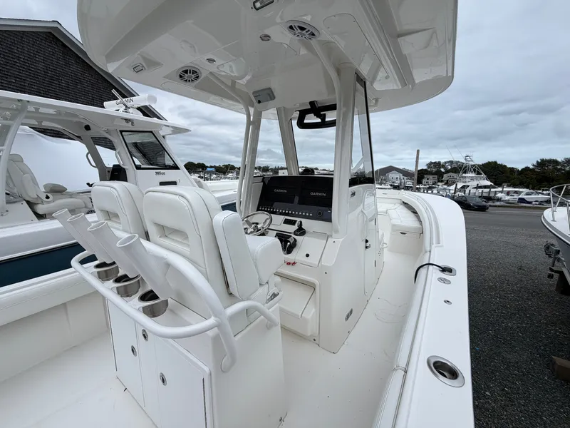 Slide: The Image of The image shows a 2021 Regulator 28 boat with white interior and modern helm console. - 20