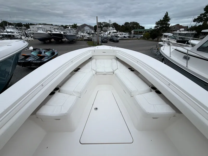 Slide: The Image of The image shows the bow area of a Regulator 28 boat with white cushions. - 31