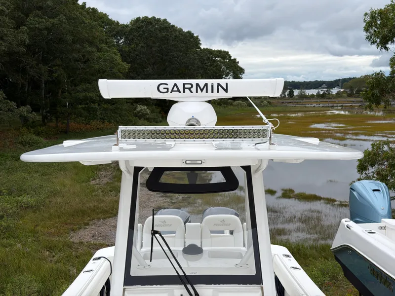 Slide: The Image of 2021 Regulator 28 with Garmin equipment, on a trailer in a green setting. - 36