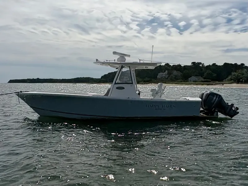 Slide: The Image of A 2021 Regulator 28 boat on the water, featuring twin outboard engines and a T-top. - 3