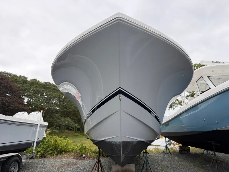 Slide: The Image of Bow view of a 2021 Regulator 28 boat, resting on a stand on land. - 7